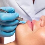 Проводится процедура перманентного макияжа губ